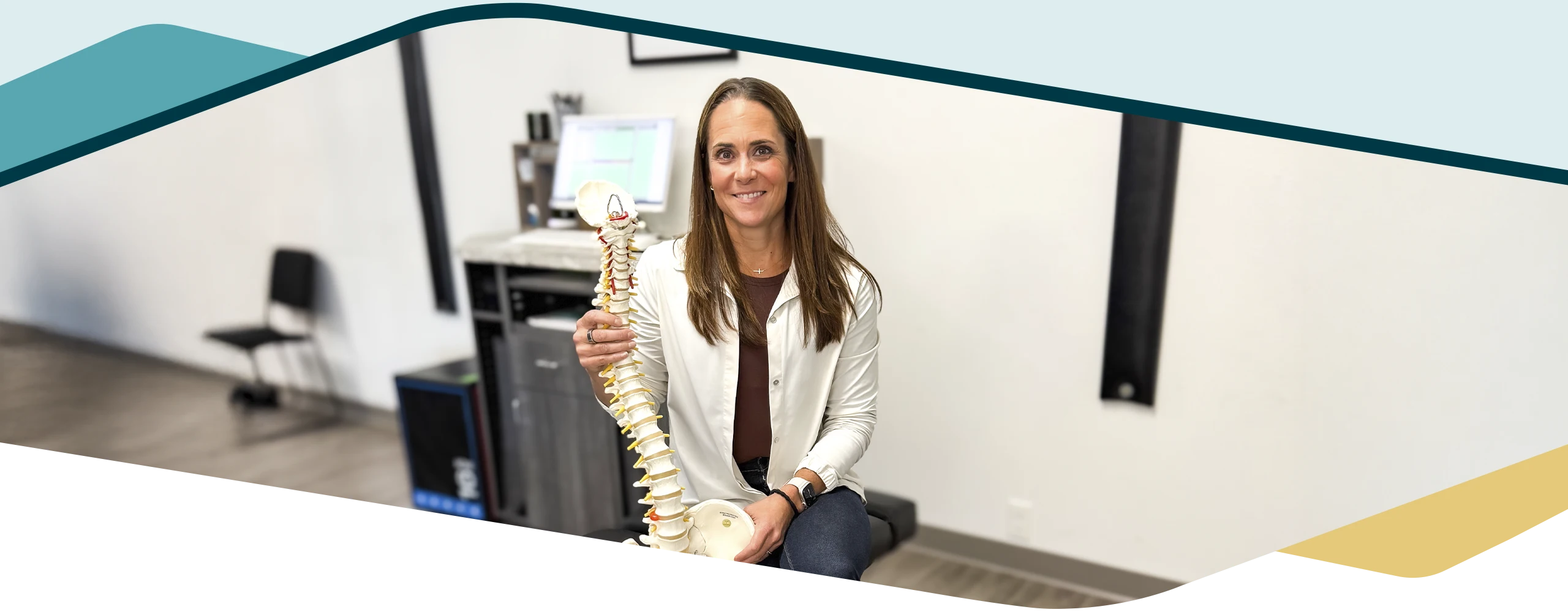 Close-up of Dr. Sandy Ager presenting a spine model, emphasizing expertise in spinal care and patient education.