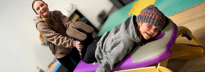 Two Girls Pretending to Be a Chiropractor and Patient in the Kids Area